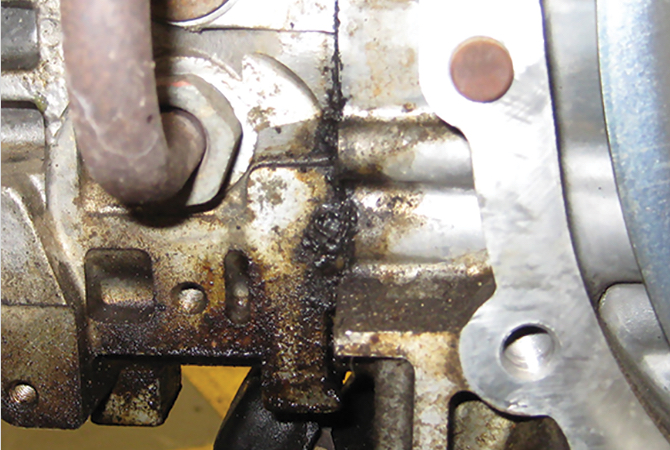 Close up view of external oil leak due to a failed gasket
