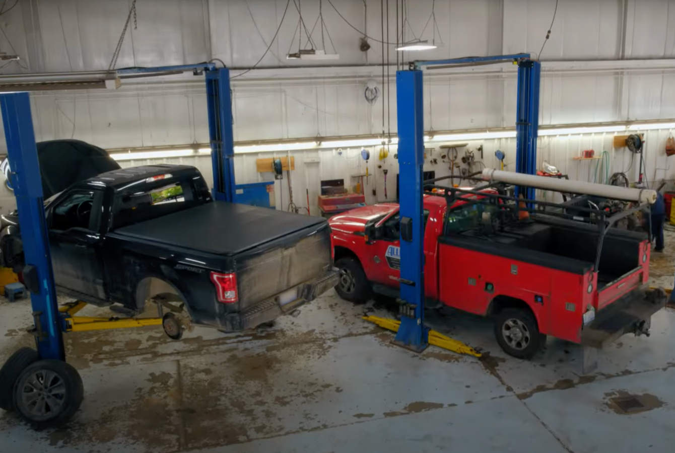 Trucks on Hoists in auto repair shop Trucks on Hoists in auto repair shop