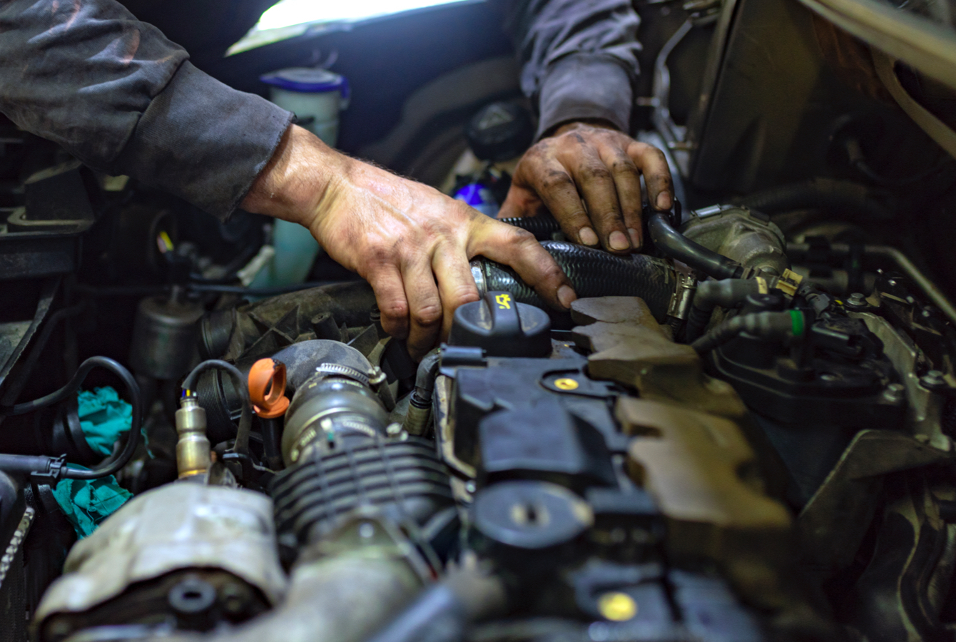 Mechanic Working On Car Engine